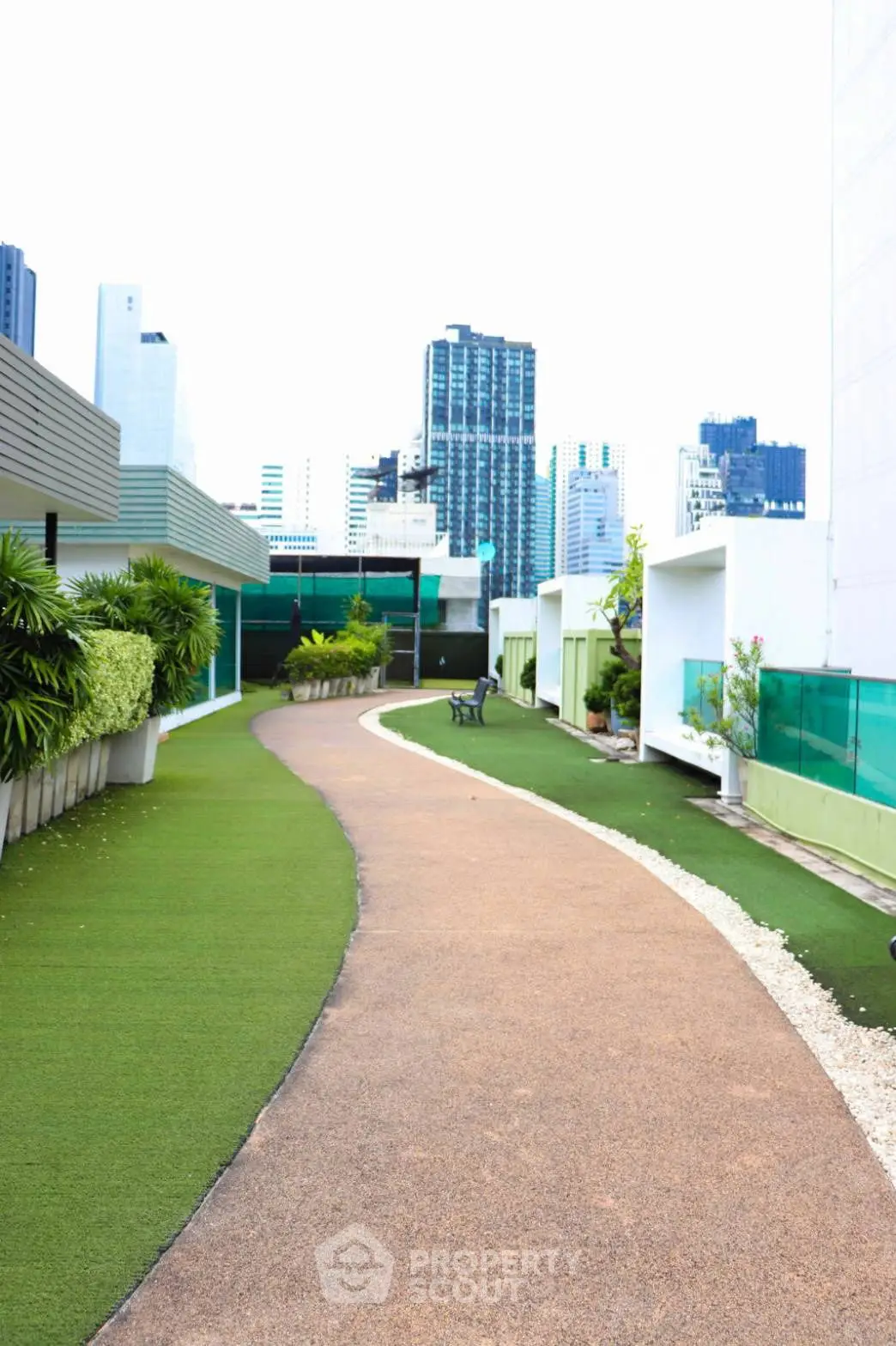Stunning rooftop garden with city skyline views and lush greenery.
