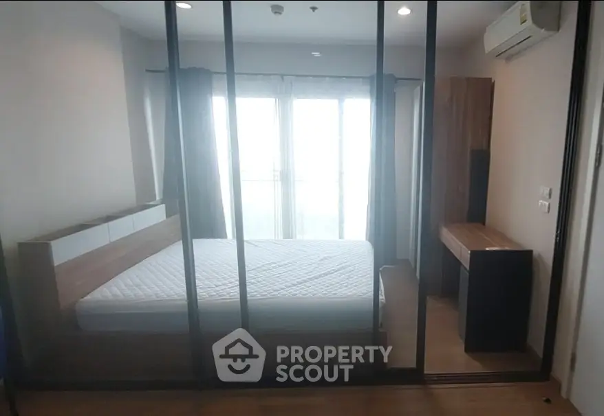 Modern bedroom with glass partition and natural light