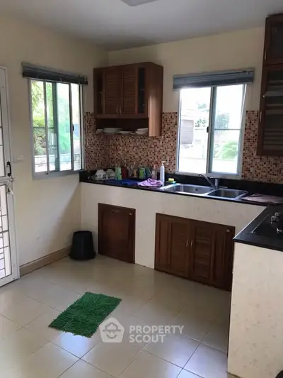 Charming kitchen with ample natural light and modern cabinetry, perfect for culinary enthusiasts.