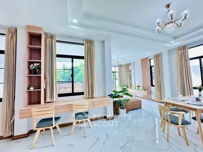 Spacious modern living room with elegant decor and large windows for natural light.