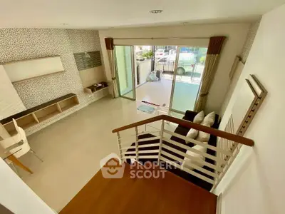 Spacious modern living room with open layout and balcony access, perfect for relaxation and entertaining.