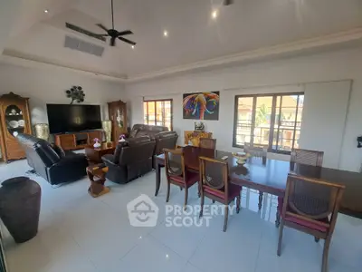 Spacious living room with elegant furniture and large windows offering natural light.