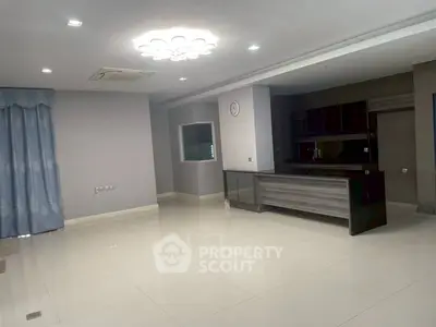 Spacious modern living area with open kitchen and elegant lighting