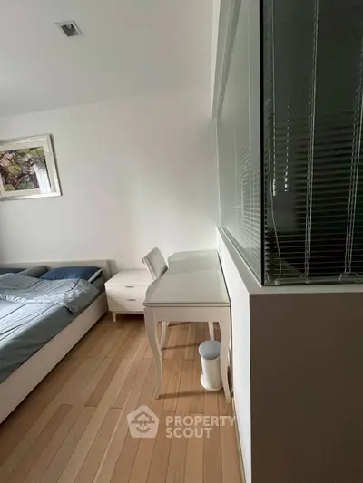 Modern bedroom with elegant desk and wooden flooring