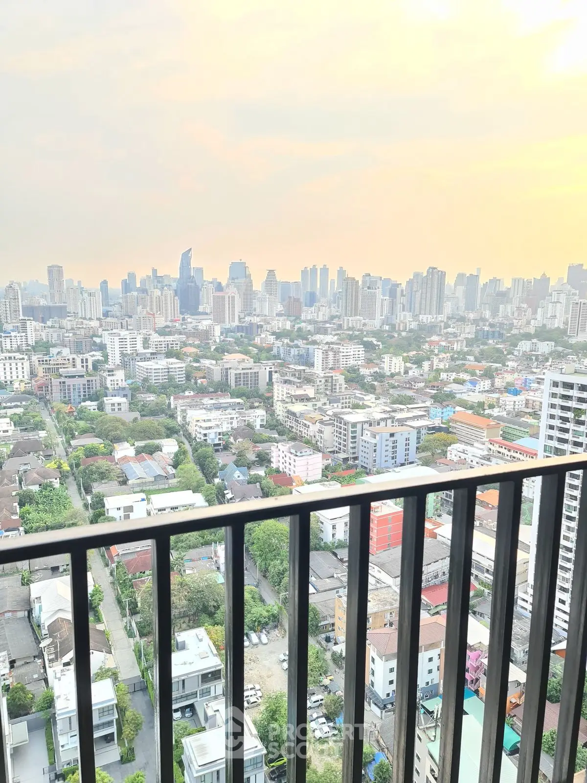Stunning cityscape view from high-rise balcony at sunset