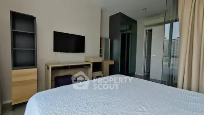 Modern bedroom with TV and glass partition in a stylish apartment