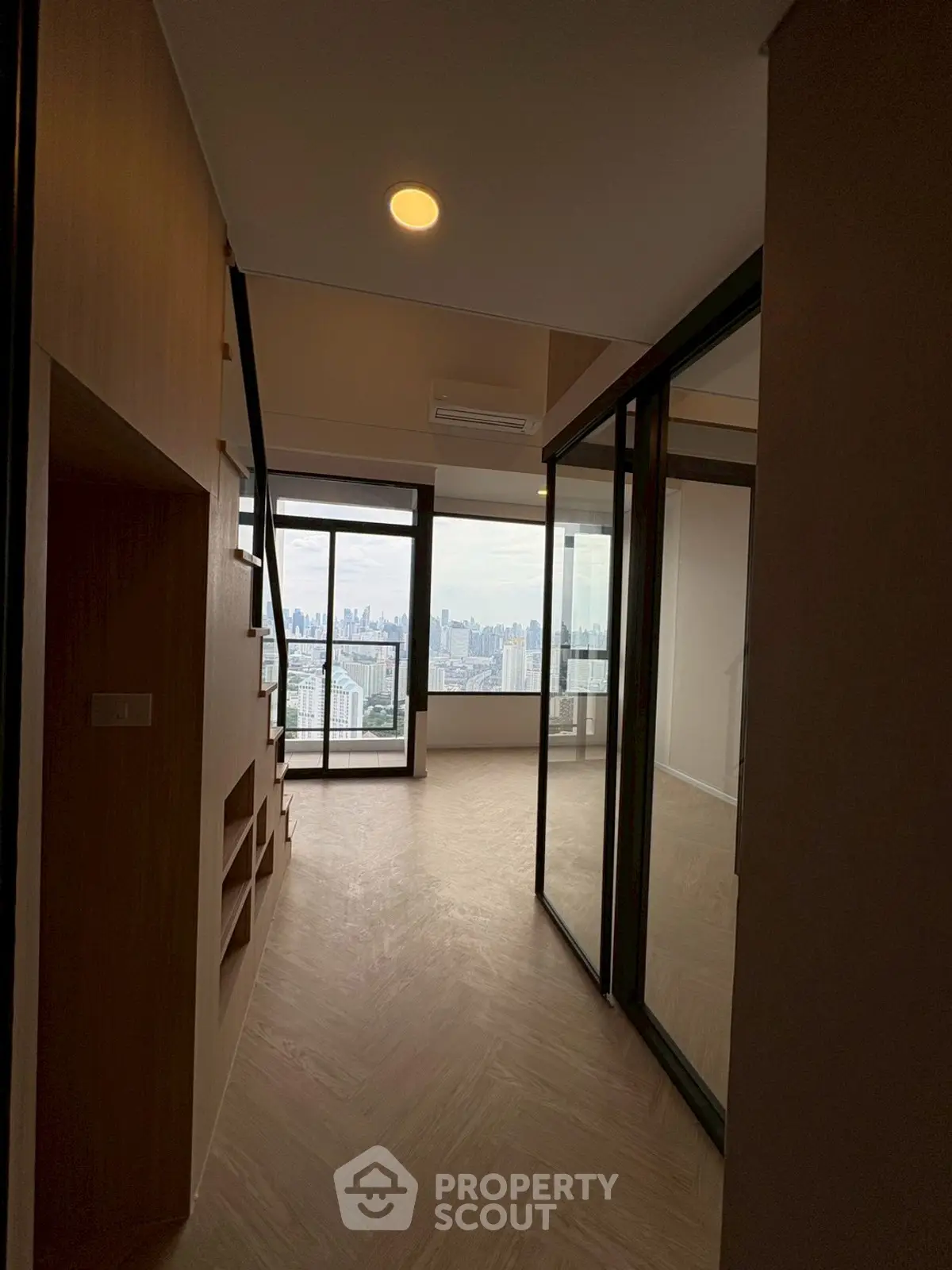 Modern apartment with glass partitions and stunning city view