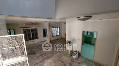 Spacious living room with tiled flooring and natural light, ideal for customization.