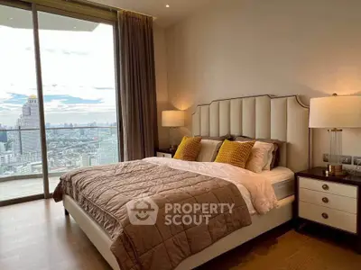 Luxurious bedroom with stunning city view and elegant decor in high-rise apartment.