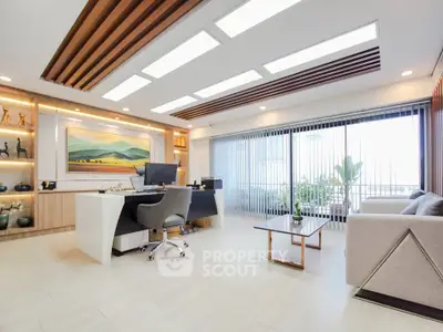 Spacious modern living room with elegant decor and large windows offering natural light.