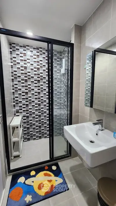 Modern bathroom with stylish tile design and glass shower enclosure