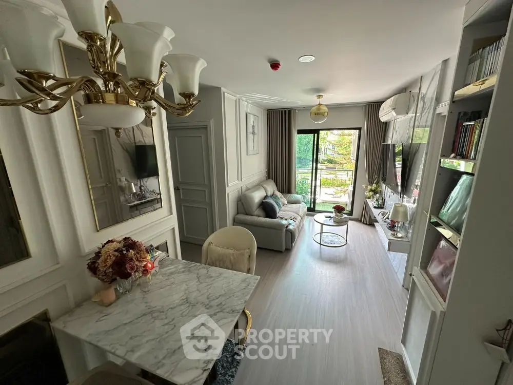 Luxurious living room with elegant decor and natural light, featuring a cozy seating area and stylish dining space.