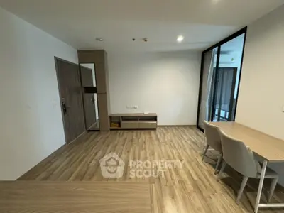 Modern minimalist living room with wooden flooring and sleek furniture