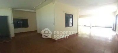 Spacious open-plan living area with tiled flooring and ample natural light, perfect for modern living.