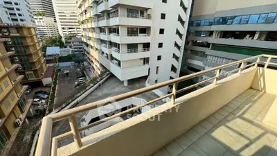 Spacious balcony with city view in modern apartment building