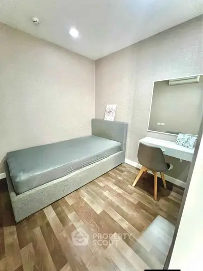 Cozy bedroom with single bed and study desk, perfect for minimalist living.