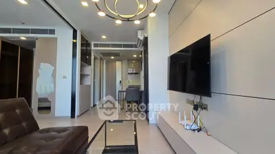 Modern living room with sleek design, featuring a wall-mounted TV and stylish furniture.