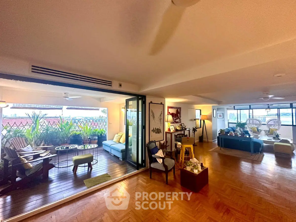 Spacious living room with open balcony and stylish decor