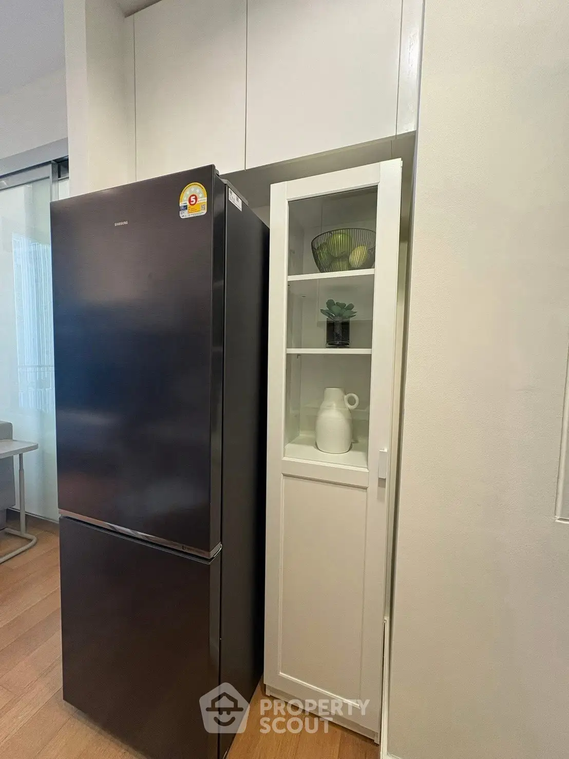 Modern kitchen with sleek black refrigerator and stylish storage cabinet