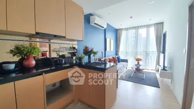 Modern open-plan living room with stylish kitchen and balcony view