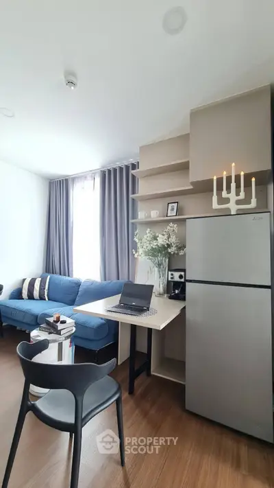 Modern living room with sleek furniture and integrated workspace, featuring a cozy sofa and stylish decor.