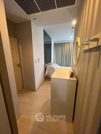 Modern bedroom with stylish decor and natural light, featuring a cozy bed and elegant furnishings.