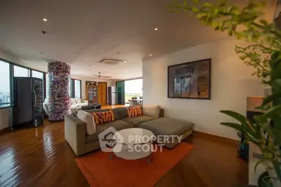 Spacious modern living room with panoramic city views and stylish decor.