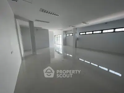 Spacious open-plan interior with glossy floors and ample natural light, ideal for versatile real estate opportunities.