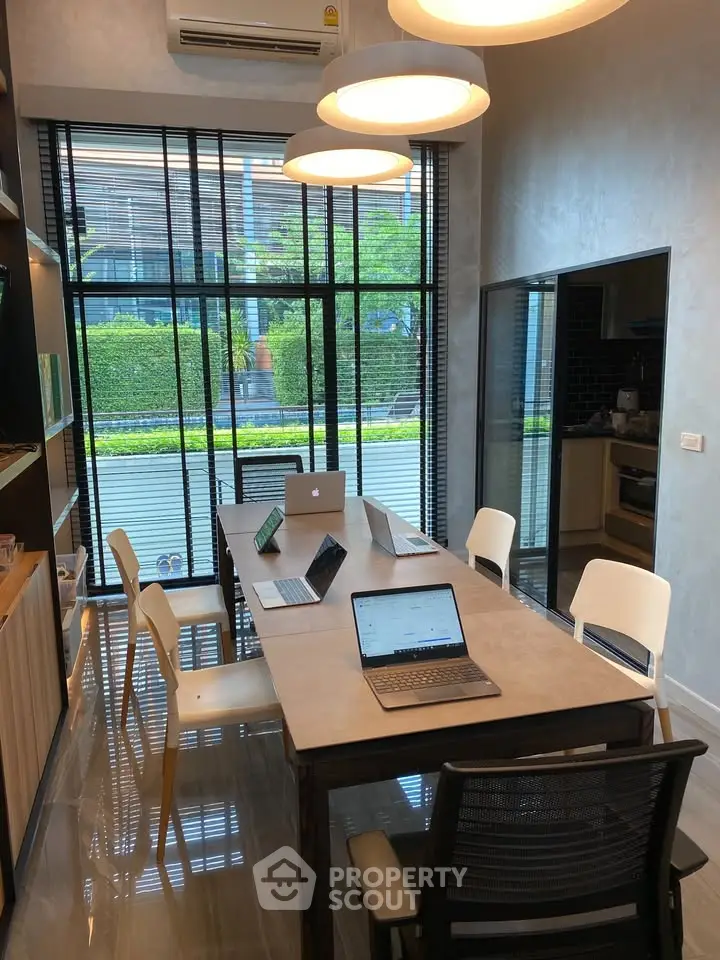 Modern study room with large windows and sleek furniture, perfect for productivity and comfort.