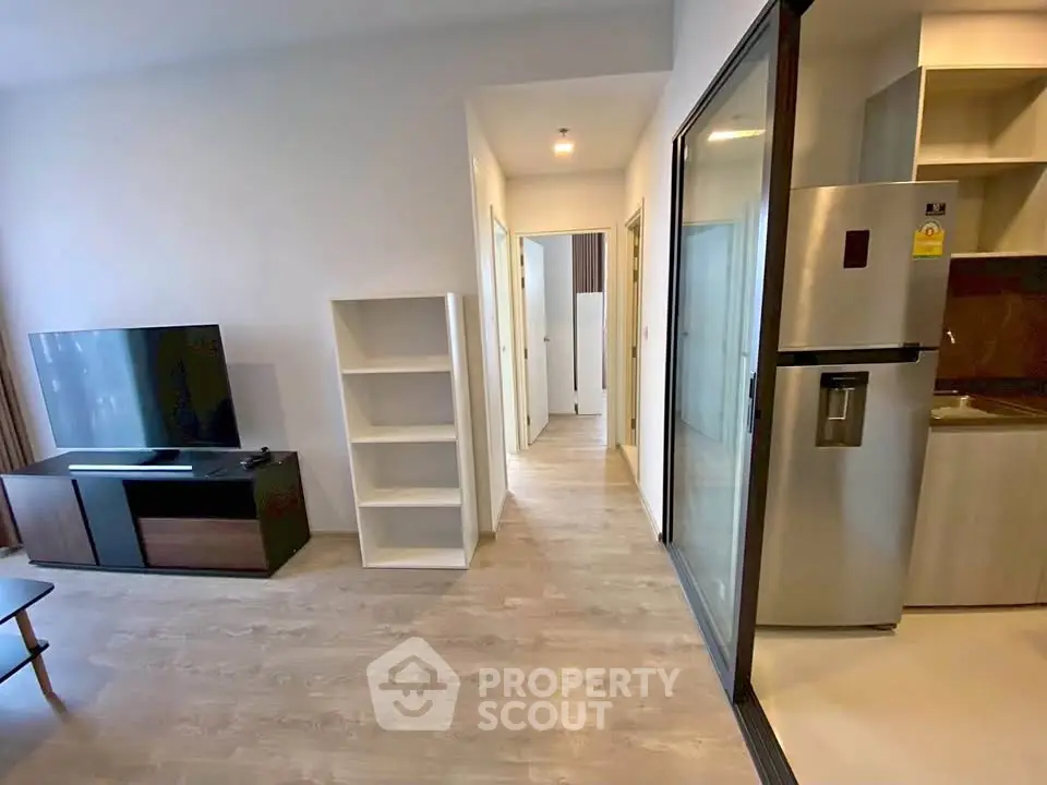 Modern apartment interior with open living area and sleek kitchen design.