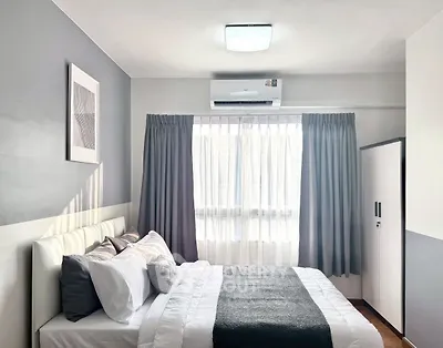 Modern bedroom with stylish decor and natural light