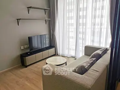 Modern living room with sleek furniture and large windows offering ample natural light.