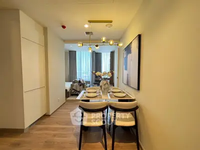 Elegant dining area with modern decor and cozy living room view in a stylish apartment.