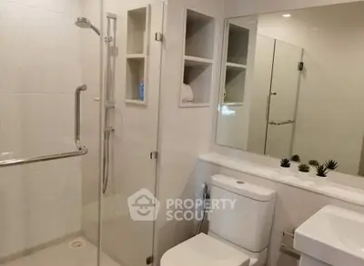 Modern bathroom with glass shower enclosure and sleek fixtures