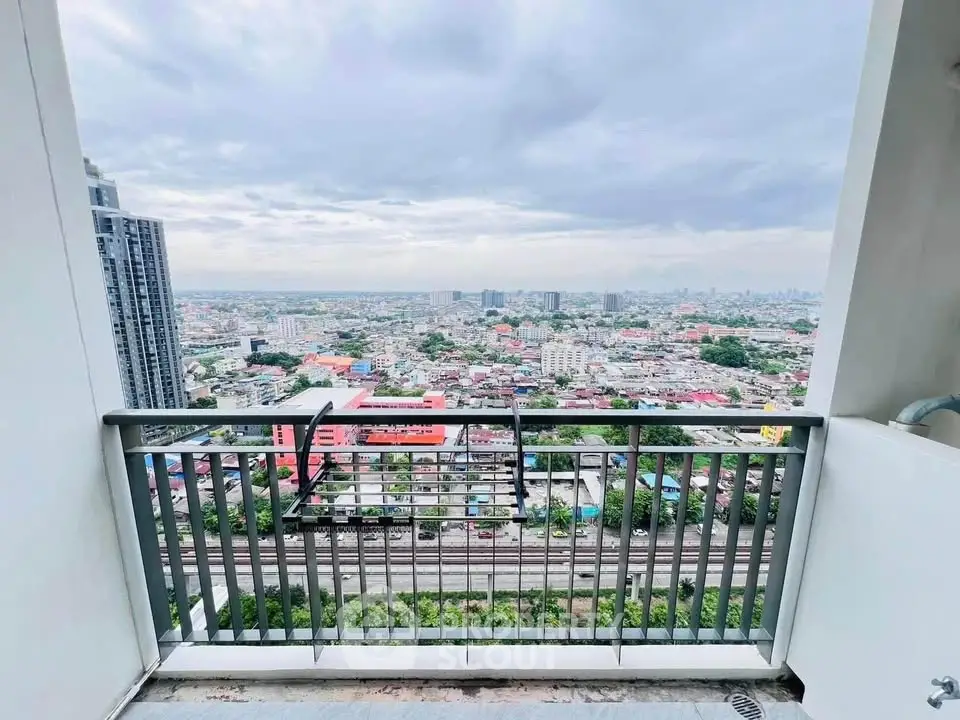 Stunning high-rise balcony view overlooking cityscape with expansive skyline.