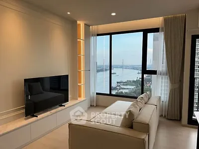 Modern living room with stunning river view and sleek furniture