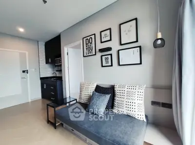 Modern living room with stylish decor and cozy seating in open layout apartment.