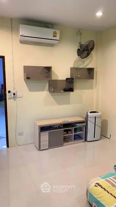 Modern living room with air conditioning and sleek shelving