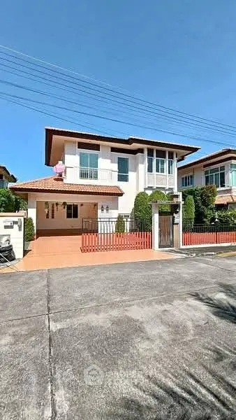 Charming two-story house with spacious driveway and modern exterior design in a serene neighborhood.