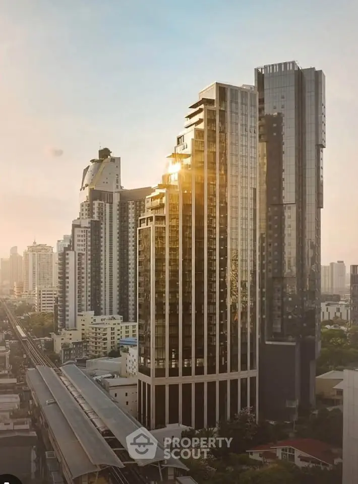 Stunning high-rise building with modern architecture and panoramic city views at sunset.