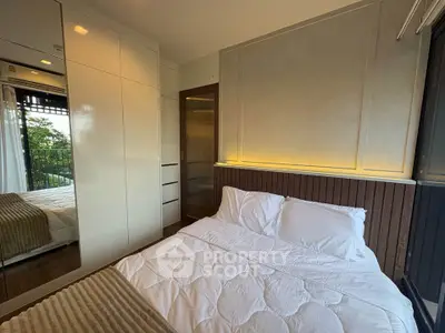Cozy modern bedroom with elegant lighting and large window view