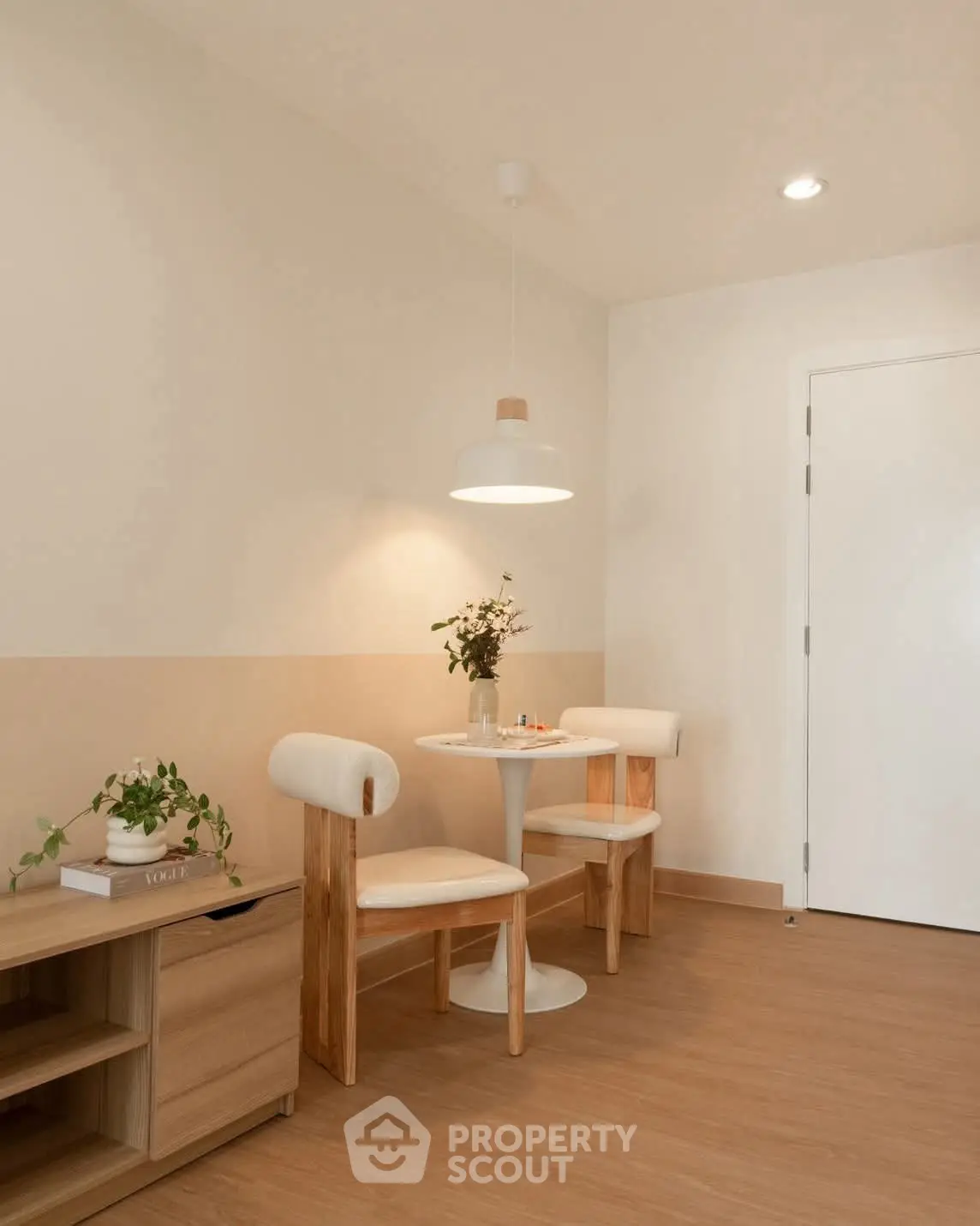 Cozy dining nook with modern chairs and table in minimalist interior design.