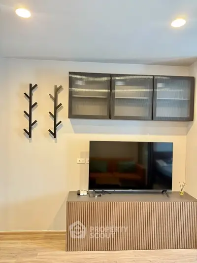 Modern living room with sleek TV stand and stylish wall-mounted shelves