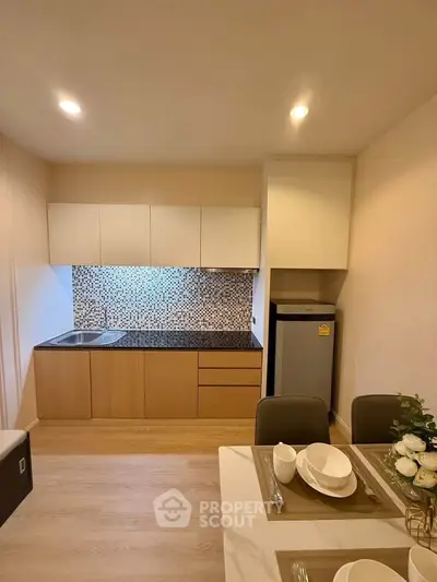 Modern kitchen with sleek cabinetry and dining setup