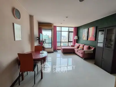 Spacious living room with modern decor and city view, featuring a cozy seating area and dining table.