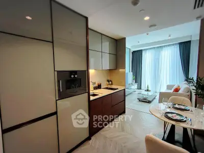 Modern open-layout kitchen and living room with elegant decor and natural light.