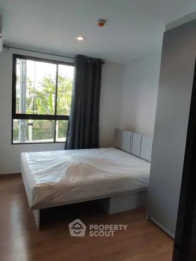Modern bedroom with large window and natural light