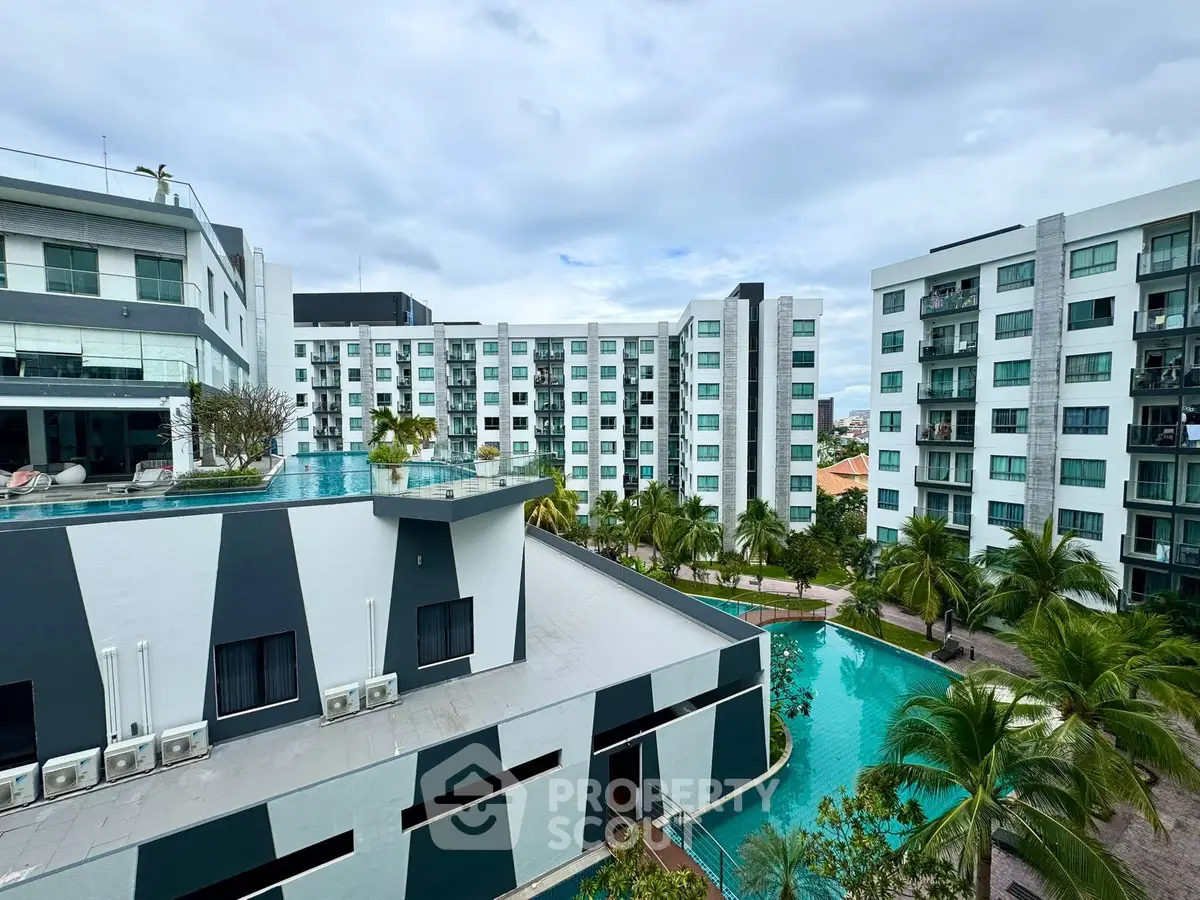 Modern apartment complex with pool and lush landscaping