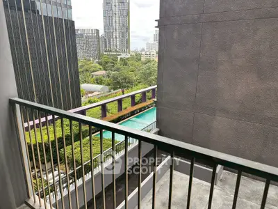 Modern urban balcony with city view and pool, perfect for relaxation.