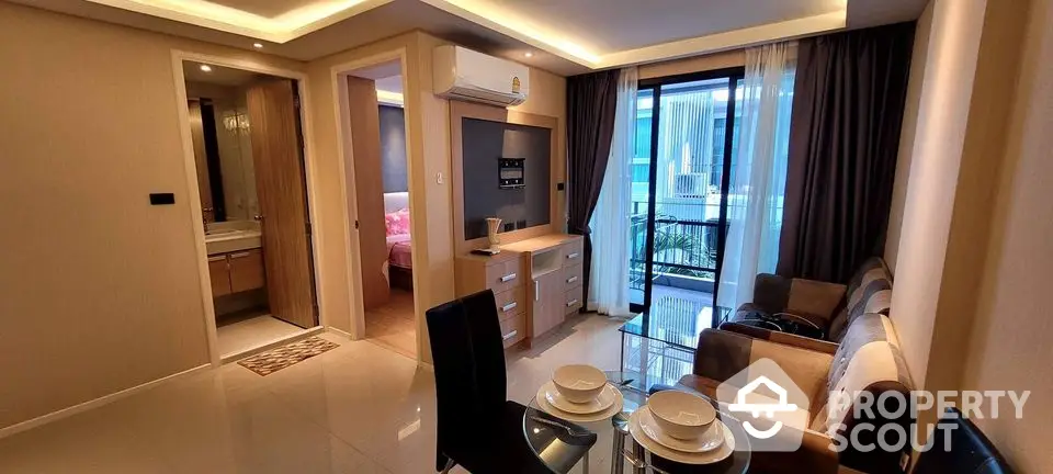 Modern living room with dining area, balcony view, and stylish decor in a contemporary apartment.